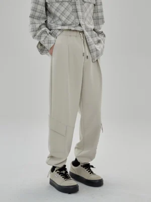 Light khaki cargo pants waist detail drawstring elastic waistband metal eyelet close-up focus men's casual