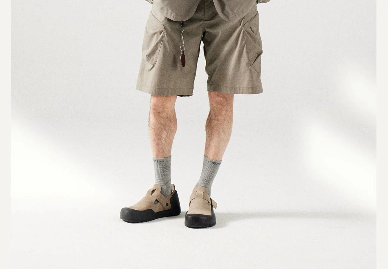 Khaki men's cargo shorts shown from the rear and side with a relaxed fit, zippered pocket, and adjustable drawstring waistband