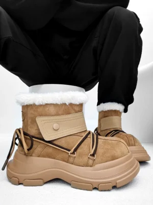 Khaki chunky platform shearling snow boots with brown wraparound laces worn with black pants in a front overhead studio view