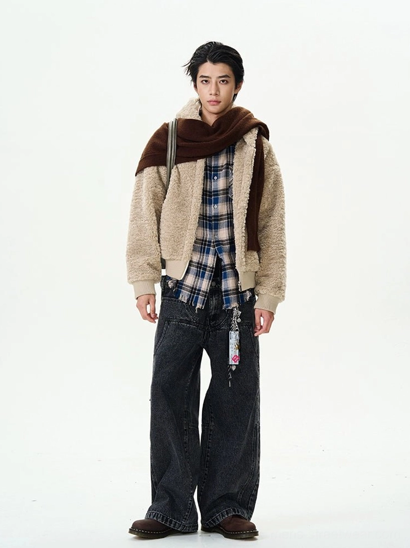 Khaki fleece hooded zip bomber jacket worn open over blue plaid shirt and wide-leg jeans