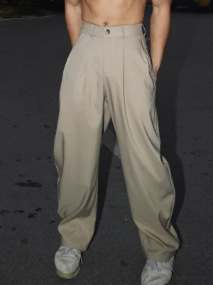 Khaki Korean streetwear wide-leg pleated trousers shown in a front low-angle full-body outdoor night street style look with high waist and relaxed tailoring