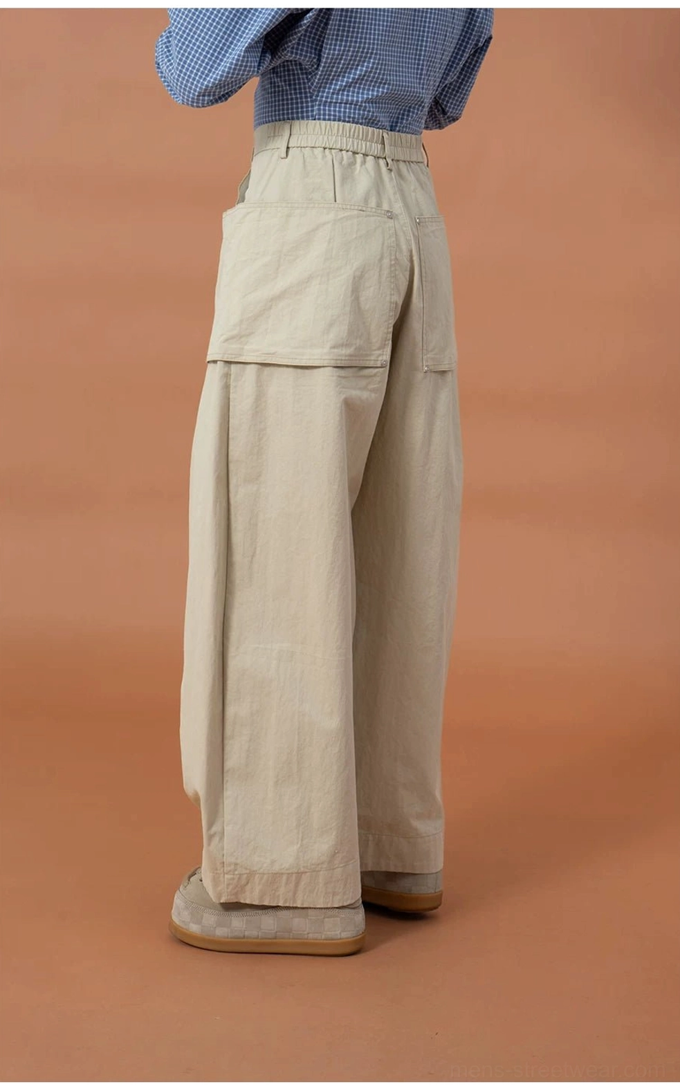 Rear side view of khaki oversized cargo pants showing the relaxed balloon-leg shape and functional back patch pocket