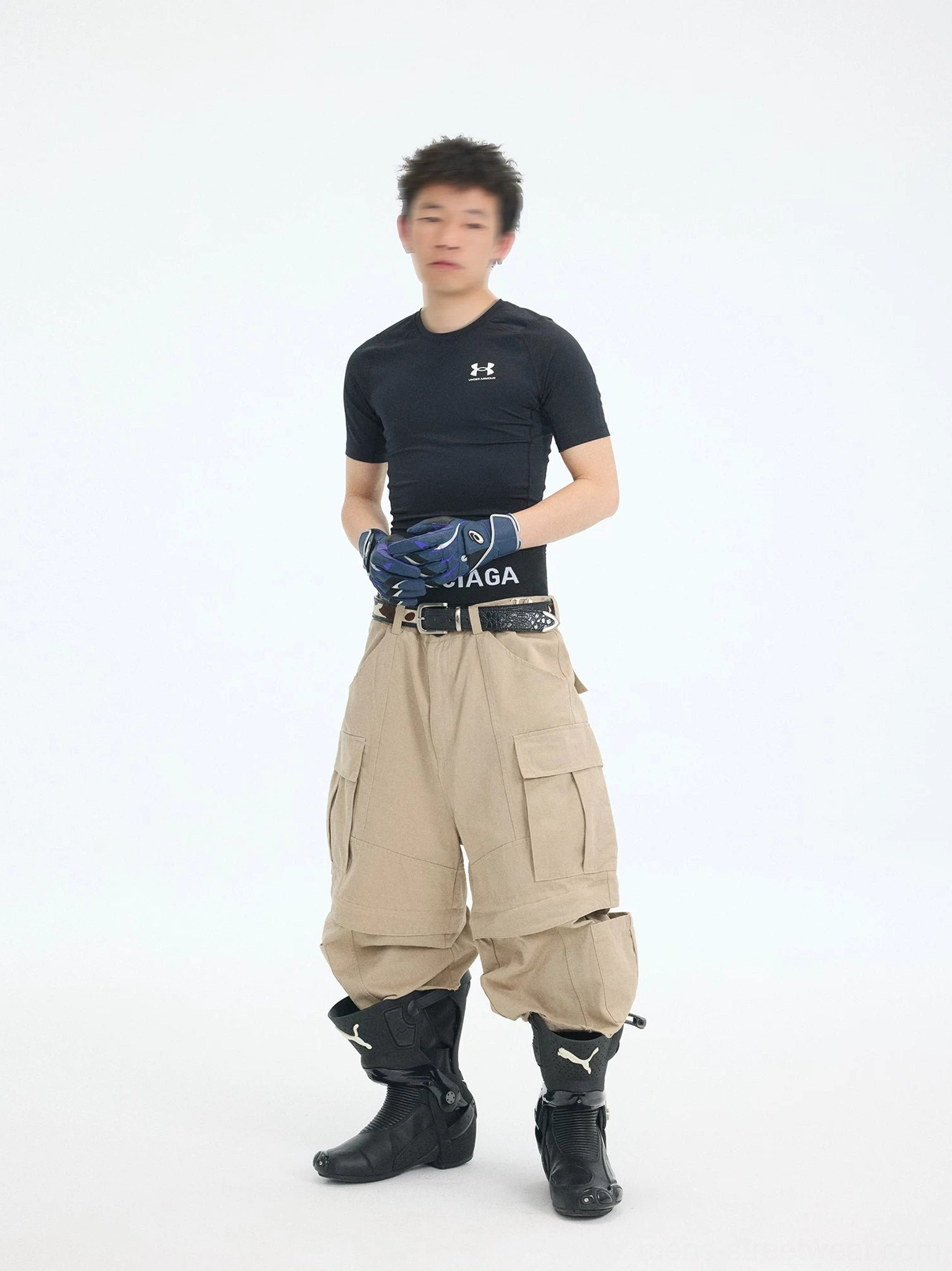 Front view of khaki oversized convertible cargo pants featuring a wide-leg fit, belt loops, large cargo pockets, and zip-off lower sections