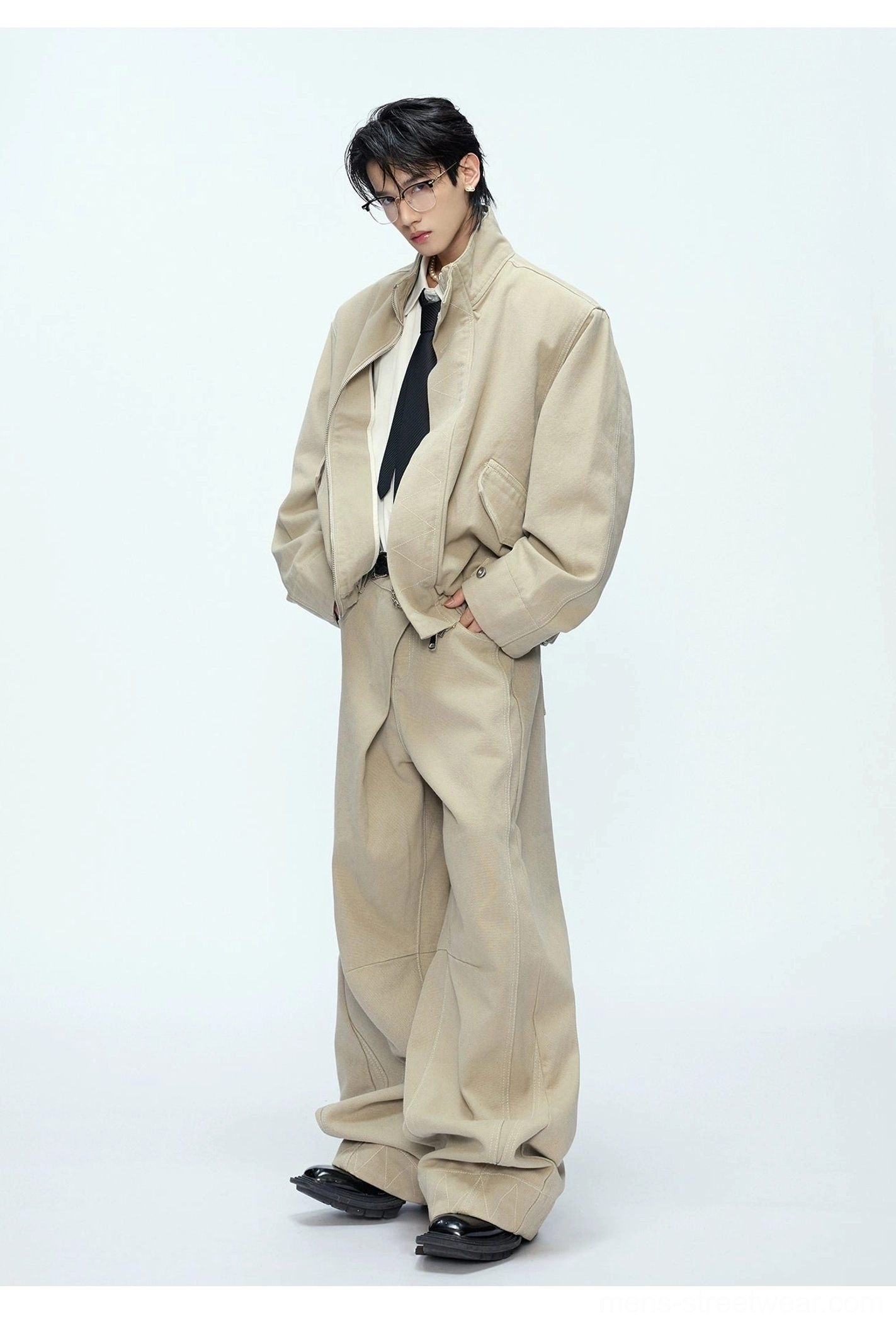 Khaki oversized cotton bomber jacket and straight wide-leg trousers side three-quarter view with relaxed dropped sleeves