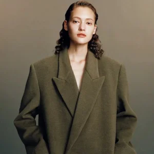 Khaki oversized wool long overcoat with wide tailored lapels and side pocket shown in a relaxed Korean fashion front view