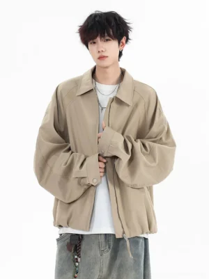 Khaki oversized zip jacket with point collar and dropped shoulders styled with layered silver necklaces