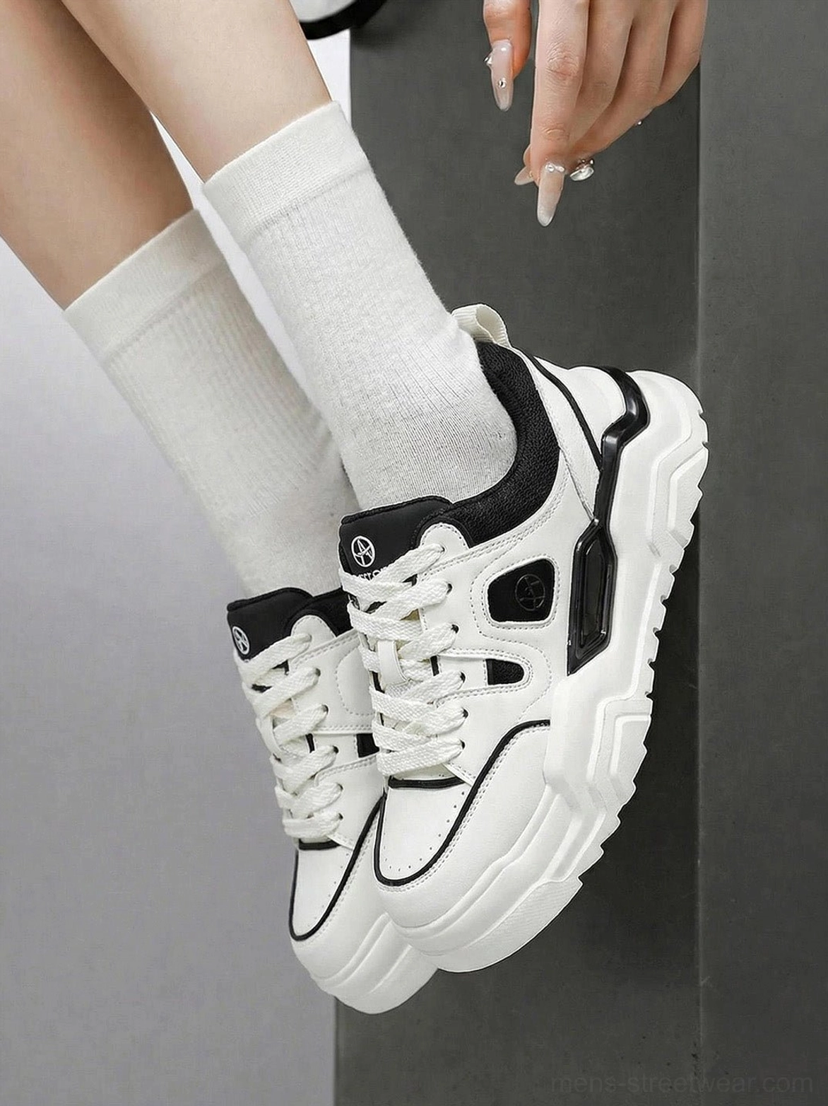 Female model wearing khaki chunky platform sneakers low angle upshot showing thick treaded sole and black inner lining details
