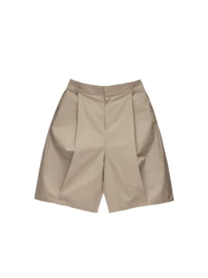 Front flat lay view of khaki pleated draped Bermuda shorts with wide loose legs and tailored Korean streetwear silhouette