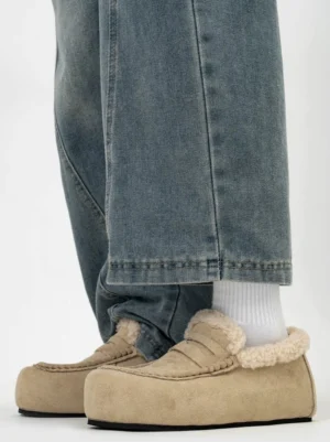 Khaki shearling lined chunky loafers with round toe platform sole worn with white socks and loose denim