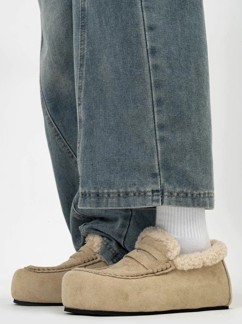 Khaki shearling lined chunky loafers with round toe platform sole worn with white socks and loose denim