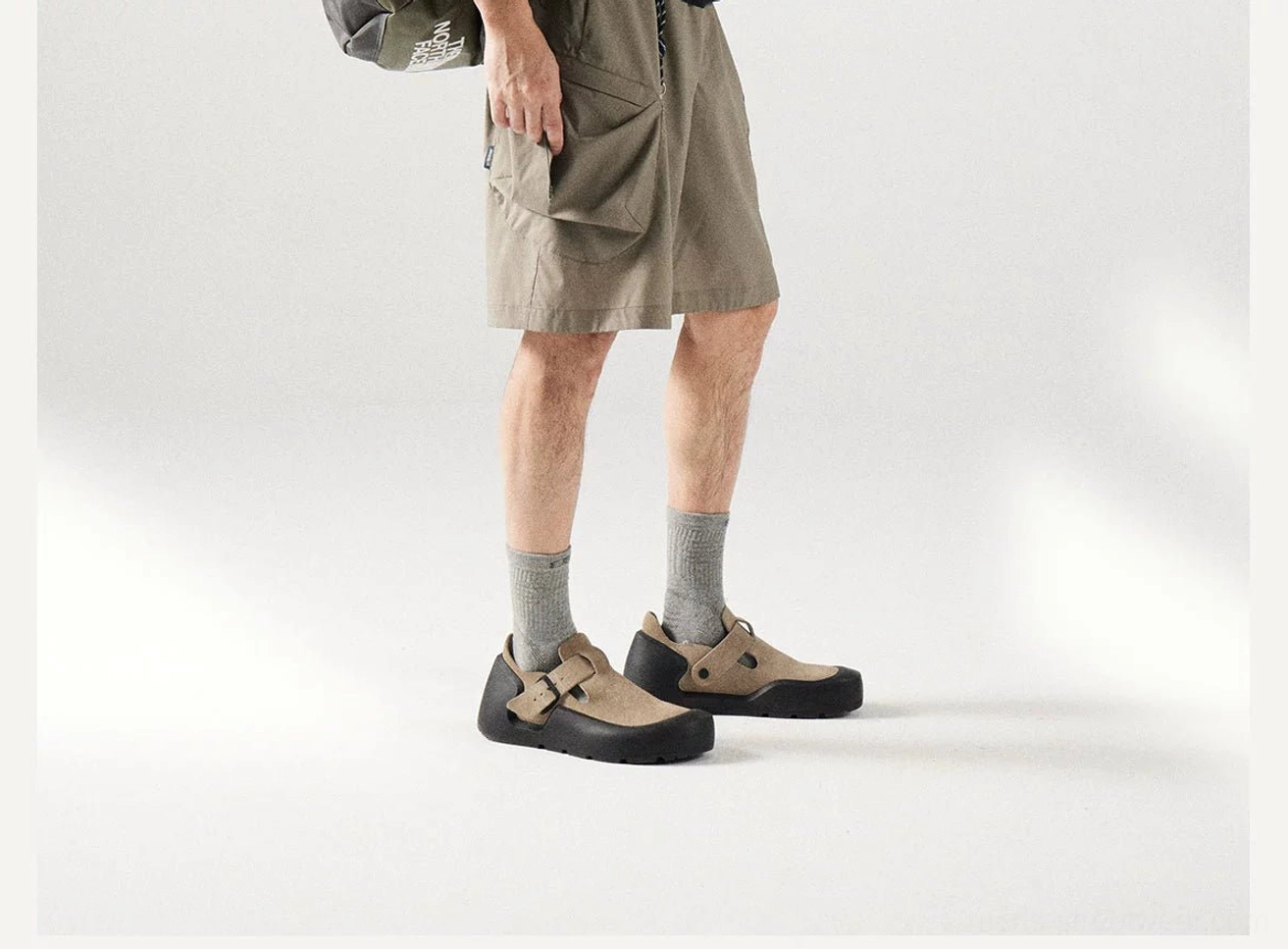 Side view of relaxed khaki cargo shorts with a straight-leg cut, clean seams, and modern gorpcore streetwear proportions