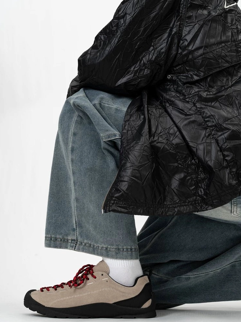 Khaki suede outdoor-inspired low-top sneakers with burgundy laces worn with relaxed blue denim and white crew socks