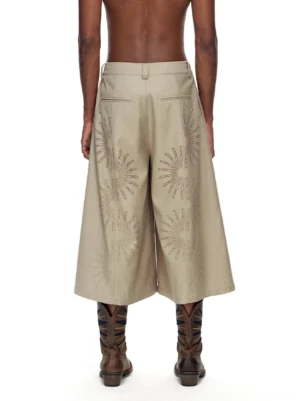 Back view of khaki cropped wide-leg trousers showing high waist belt loops, back pockets, sunburst embroidery and cropped split-leg silhouette