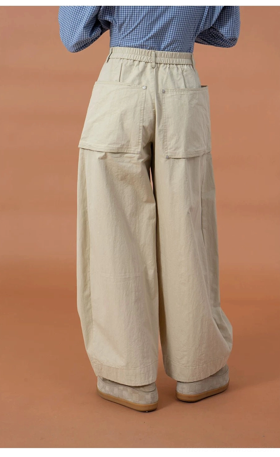 Back view of khaki oversized utility cargo pod pants with dual rear patch pockets and a clean baggy workwear finish