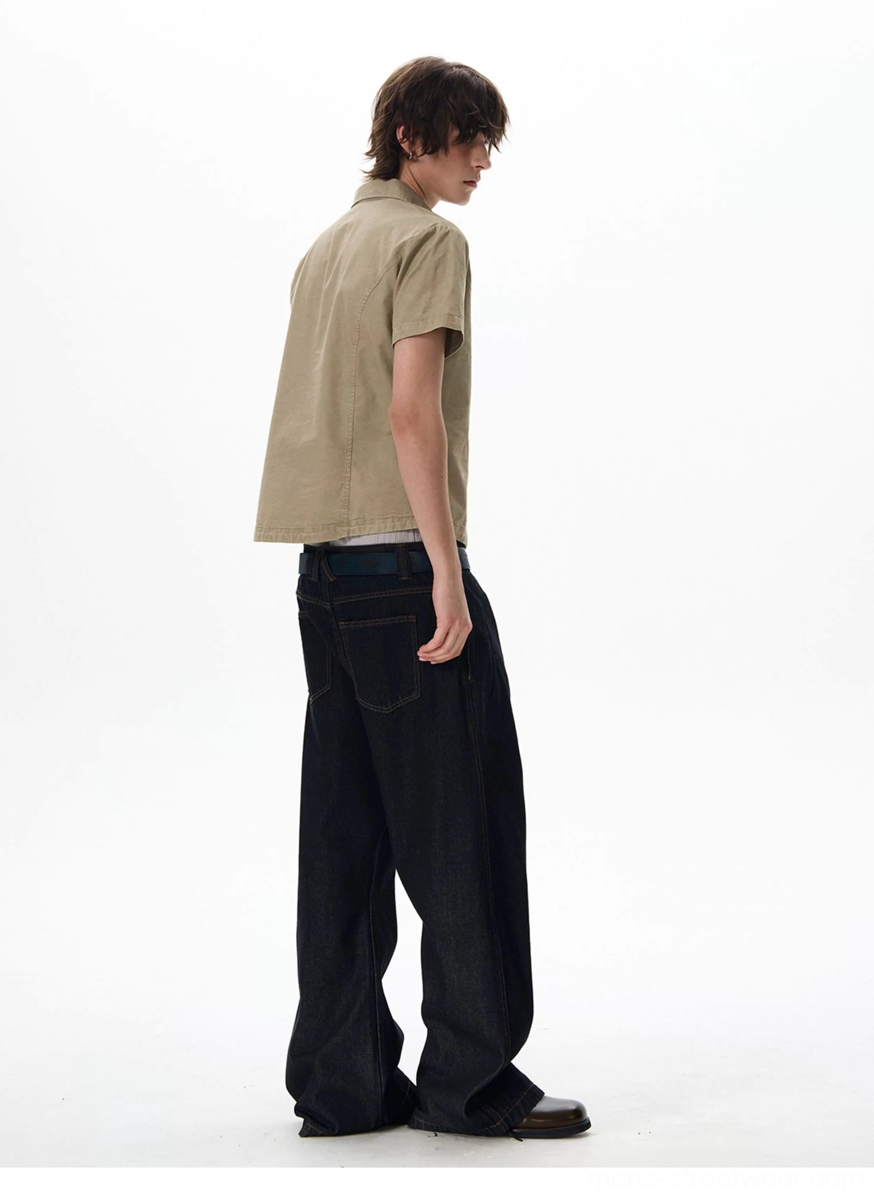 Rear side view of khaki utility shirt paired with wide-leg dark denim in urban casual styling
