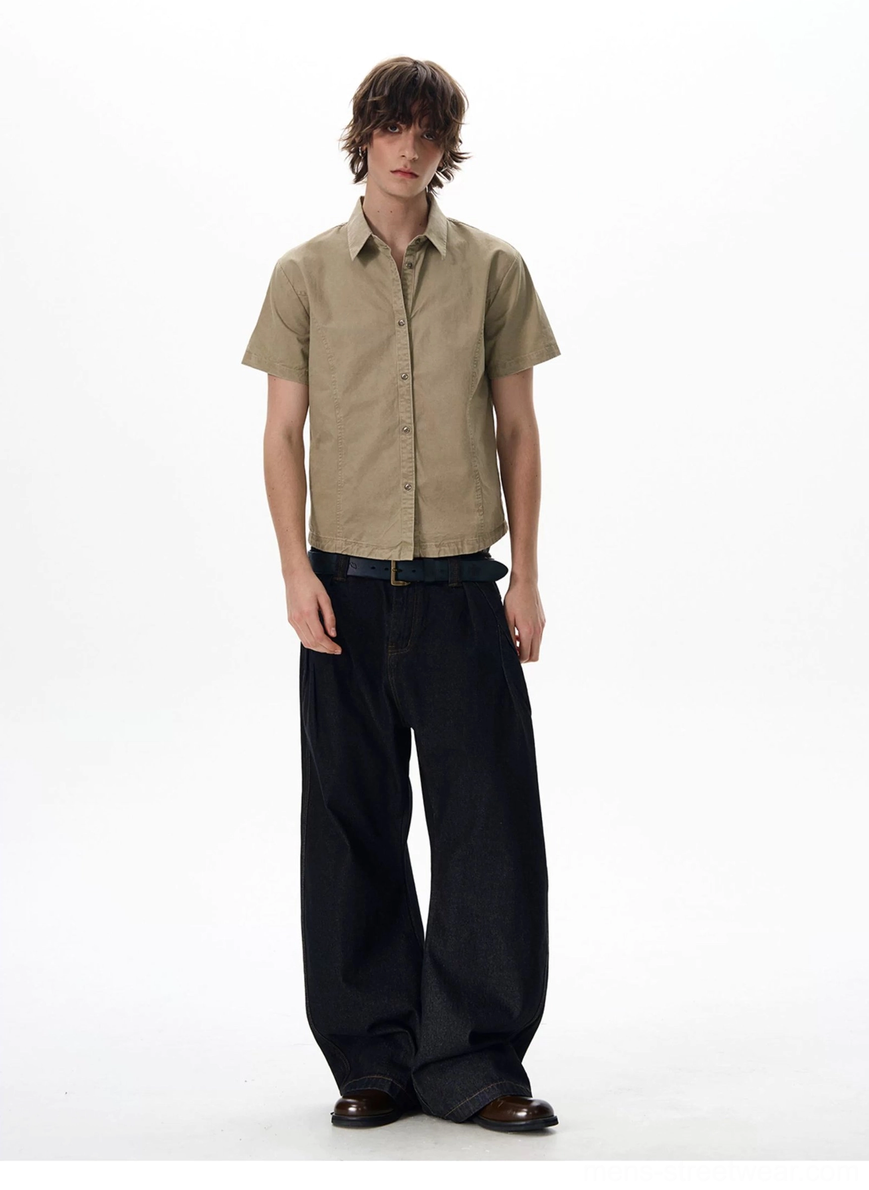 Khaki short sleeve utility shirt styled with wide-leg dark wash jeans and leather shoes