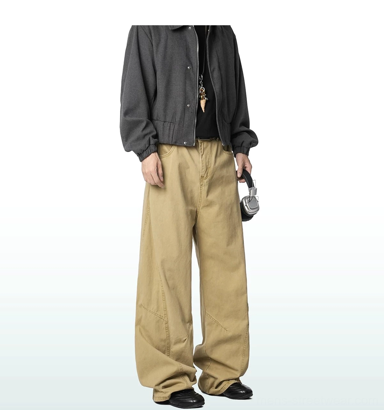 Khaki wide-leg cargo trousers styled with a dark gray cropped jacket and headphones, showing the neutral tone and relaxed Korean streetwear silhouette