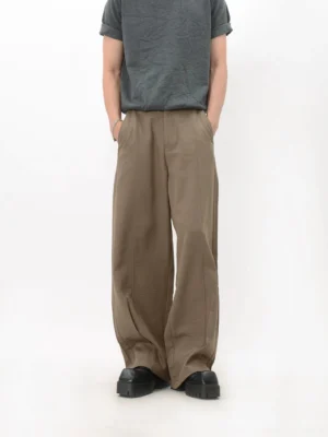 Front view of khaki wide-leg trousers showing the relaxed loose silhouette, smooth flowing fabric, and full-length streetwear fit