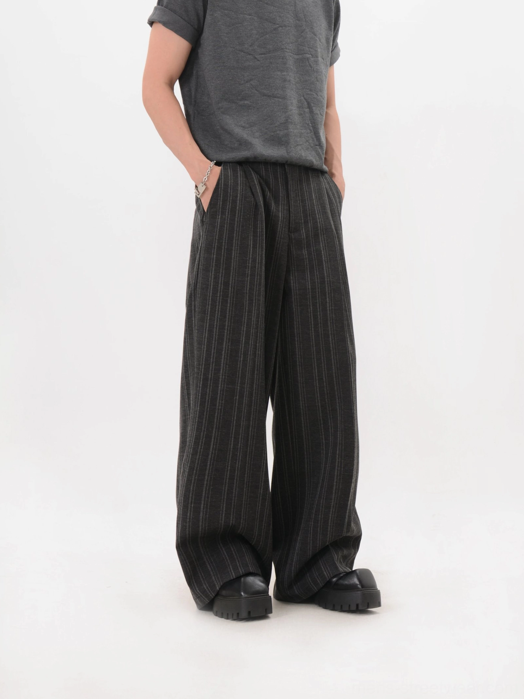Korean-inspired black pinstripe wide-leg trousers with pleated waist and chunky platform footwear