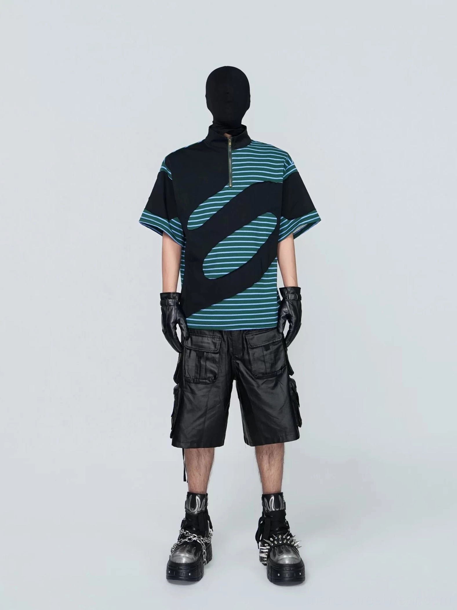 Front view of a Korean-inspired green half-zip striped tech tee featuring a black mock neck, curved color-block design, wide sleeves, and oversized boxy fit