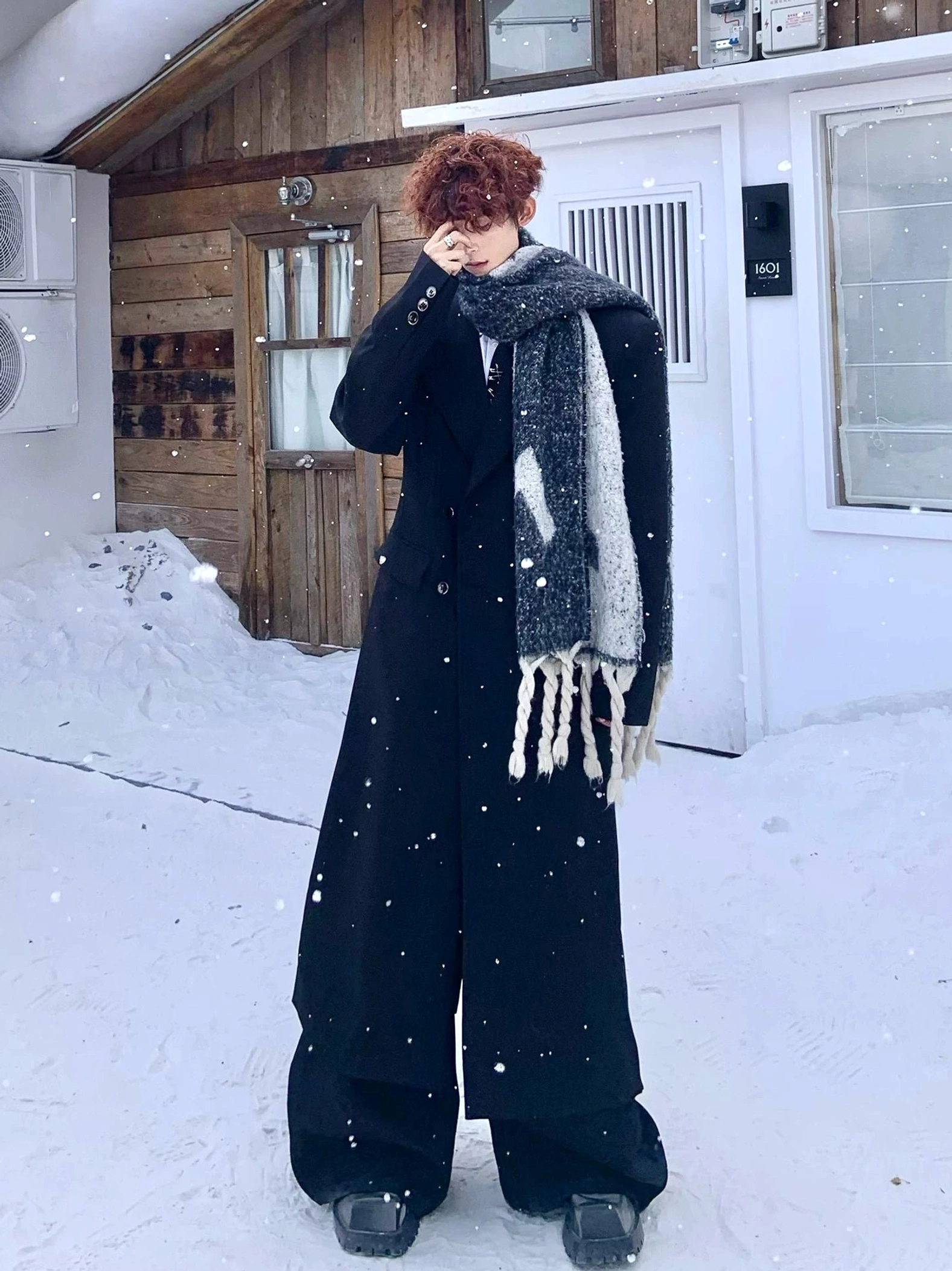 Korean streetwear black double-breasted long coat layered over tailored wide-leg trousers and scarf