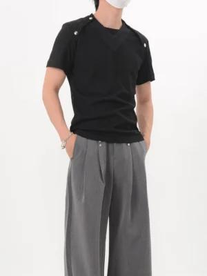 Black Korean streetwear shoulder snap fitted knit tee shown from the left front with V-shaped chest panel and metal shoulder hardware