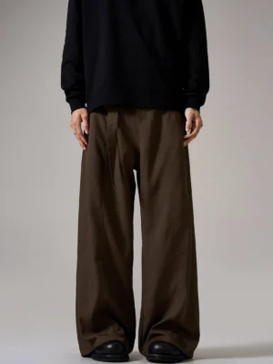 Front view of brown relaxed wide leg trousers with pleated waist and matching waist strap styled for Korean streetwear