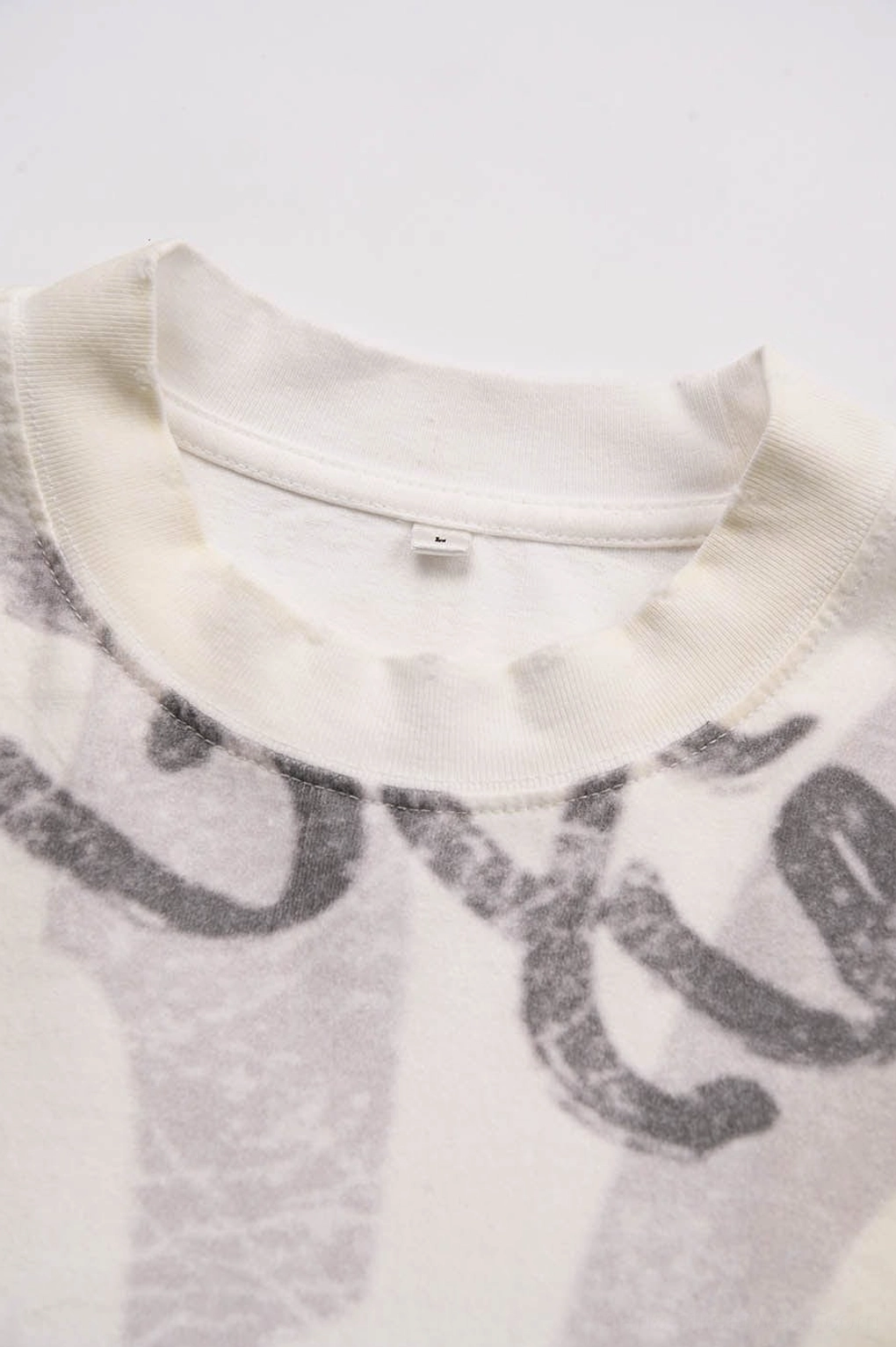Korean streetwear graphic text T-shirt with relaxed oversized proportions and retro distressed aesthetic