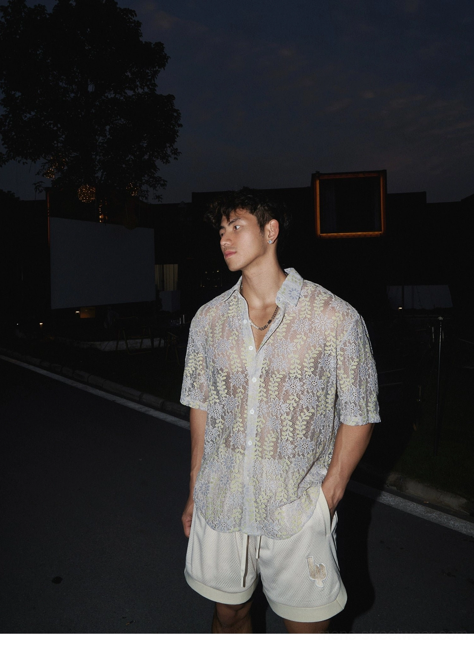 Korean streetwear mesh shorts showcasing lightweight construction, embroidered detailing, side split hem, and relaxed athletic styling