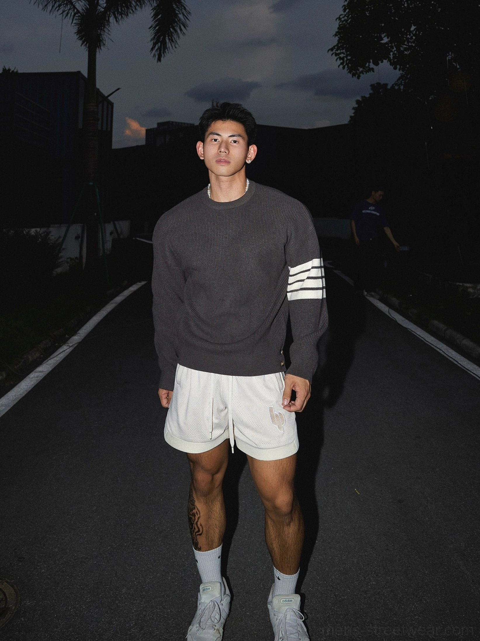 Korean streetwear striped sleeve oversized crewneck knit sweater with relaxed proportions, ribbed texture, and contemporary East Asian fashion styling