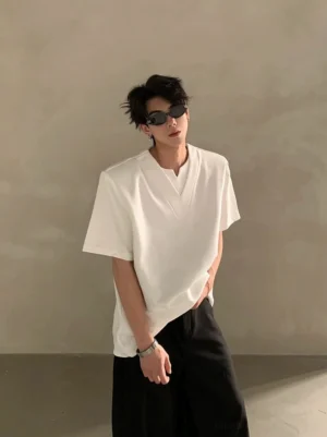 White Korean streetwear deep V notched neck short sleeve shirt shown in a relaxed three quarter front view with minimalist styling