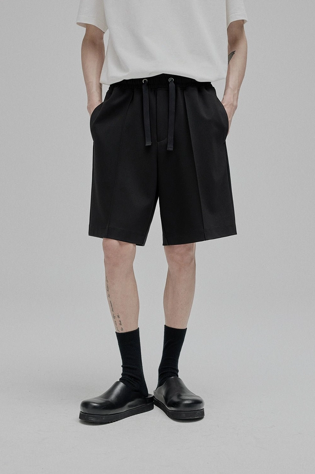 Lace-up straight leg shorts back view waist adjustment waistband decorative elements rear silhouette