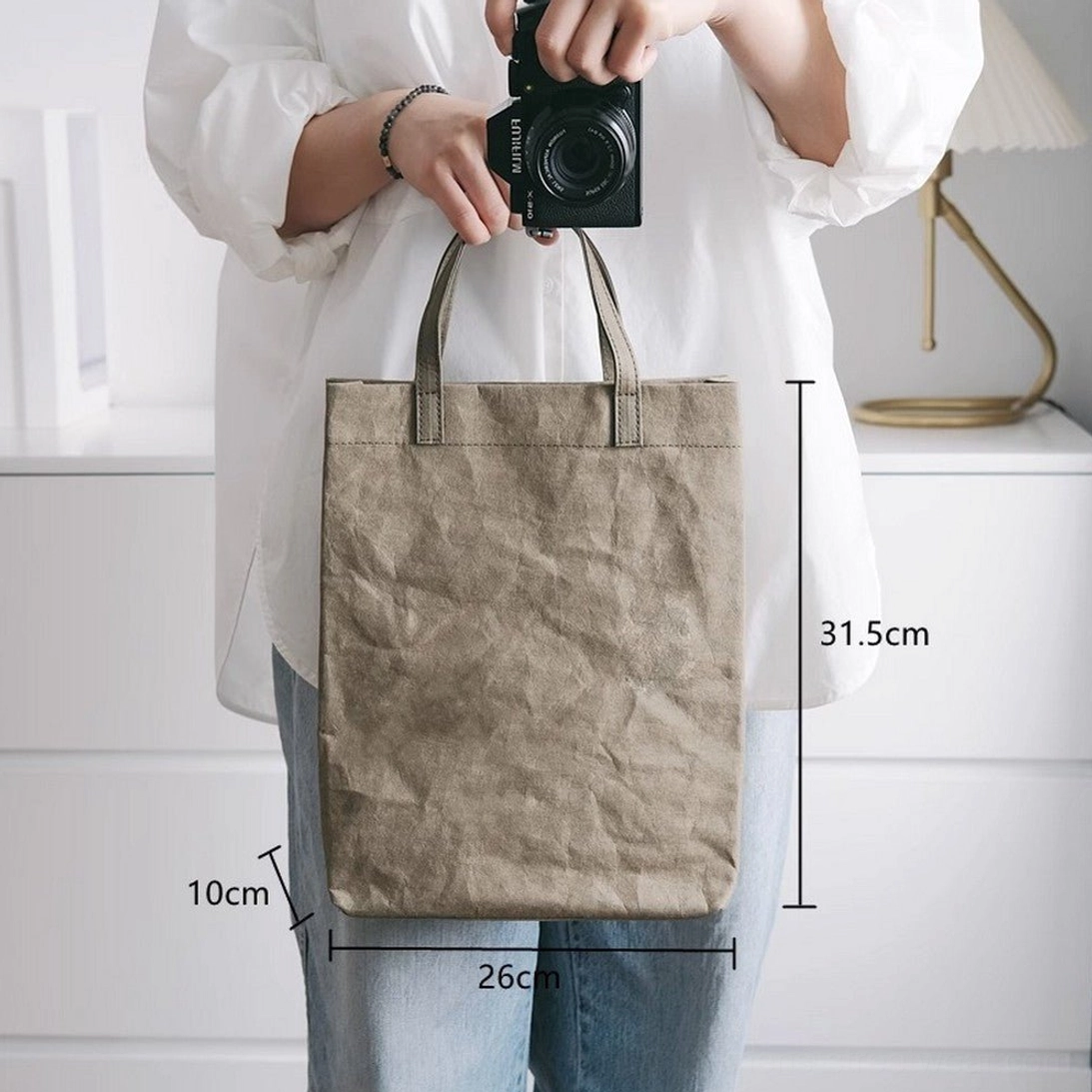 Large army green faux kraft paper texture cotton tote bag worn with casual streetwear showing roomy rectangular design