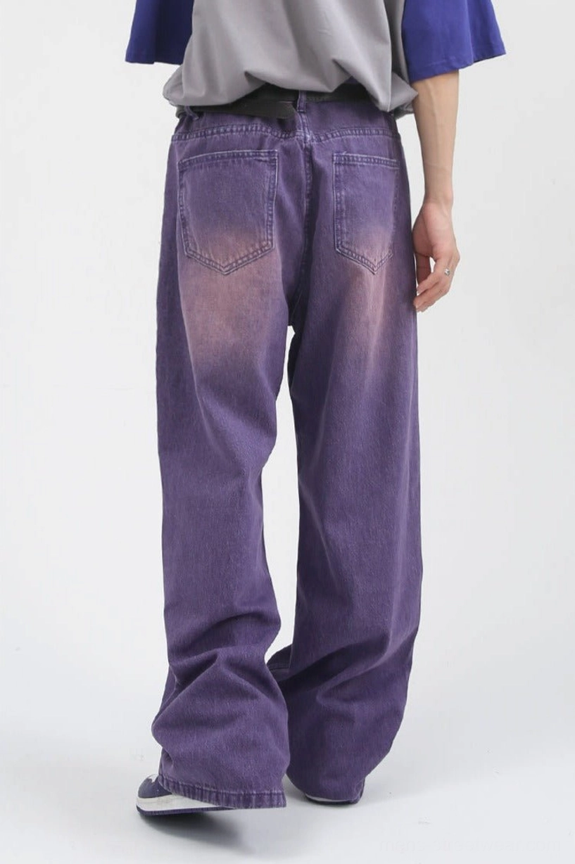 Rear full view of purple washed wide-leg carpenter jeans showing dual back pockets and long relaxed streetwear drape