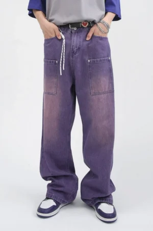 Front view of faded purple wide-leg carpenter jeans showing heart buckle detail, drawstring waist, and large front patch pockets