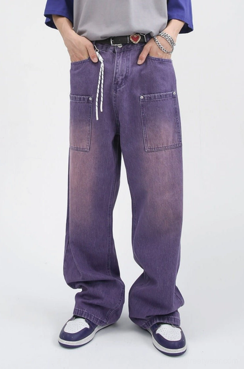 Front view of faded purple wide-leg carpenter jeans showing heart buckle detail, drawstring waist, and large front patch pockets
