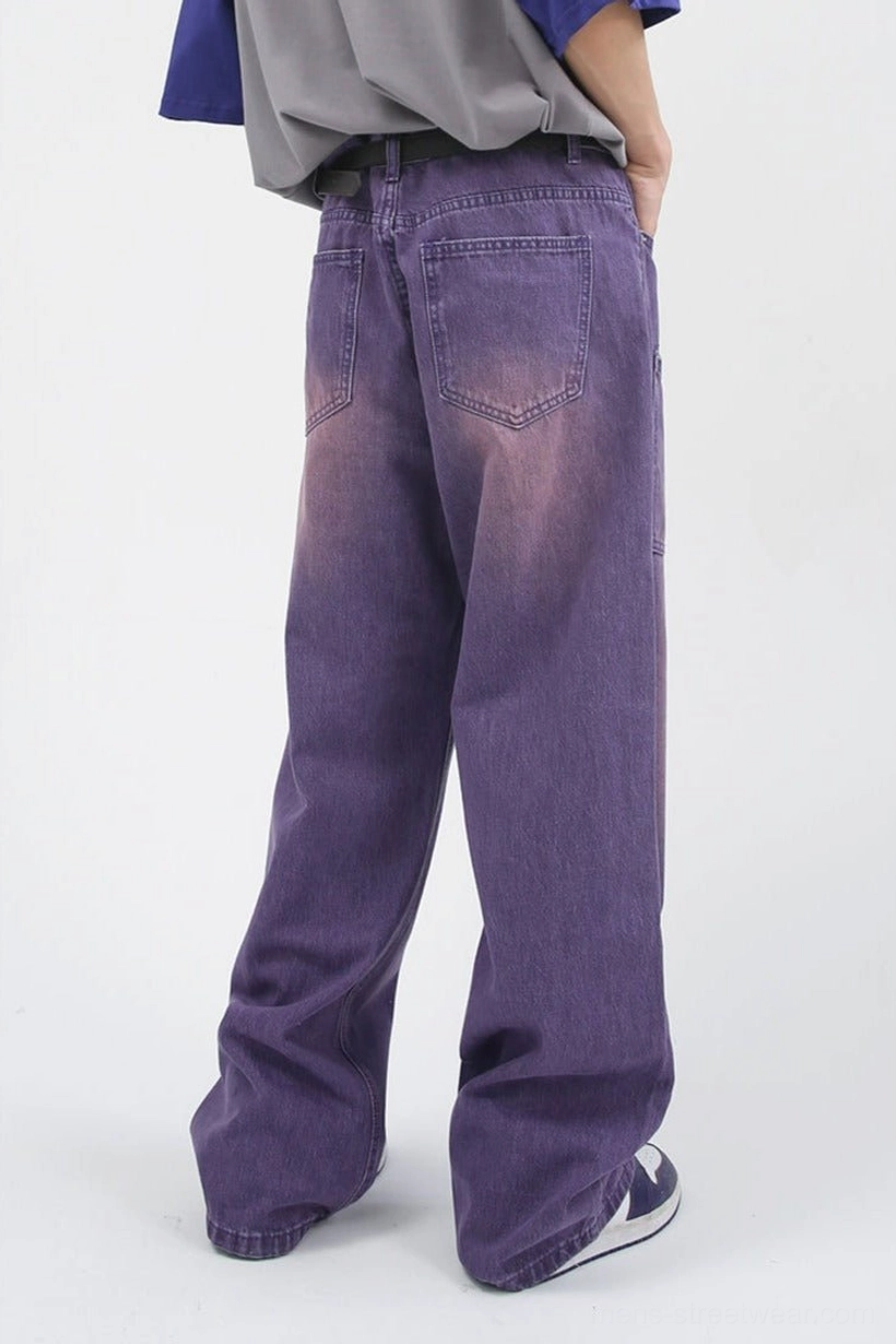 Rear three-quarter view of lavender washed carpenter jeans with classic back pockets and relaxed baggy leg shape