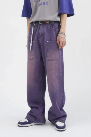 Front low-angle view of lavender washed wide-leg carpenter jeans with oversized utility patch pockets and relaxed streetwear fit
