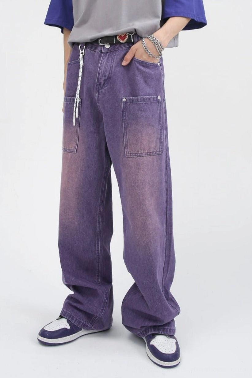Three-quarter front view of lavender washed baggy carpenter jeans with wide straight legs and oversized utility pockets