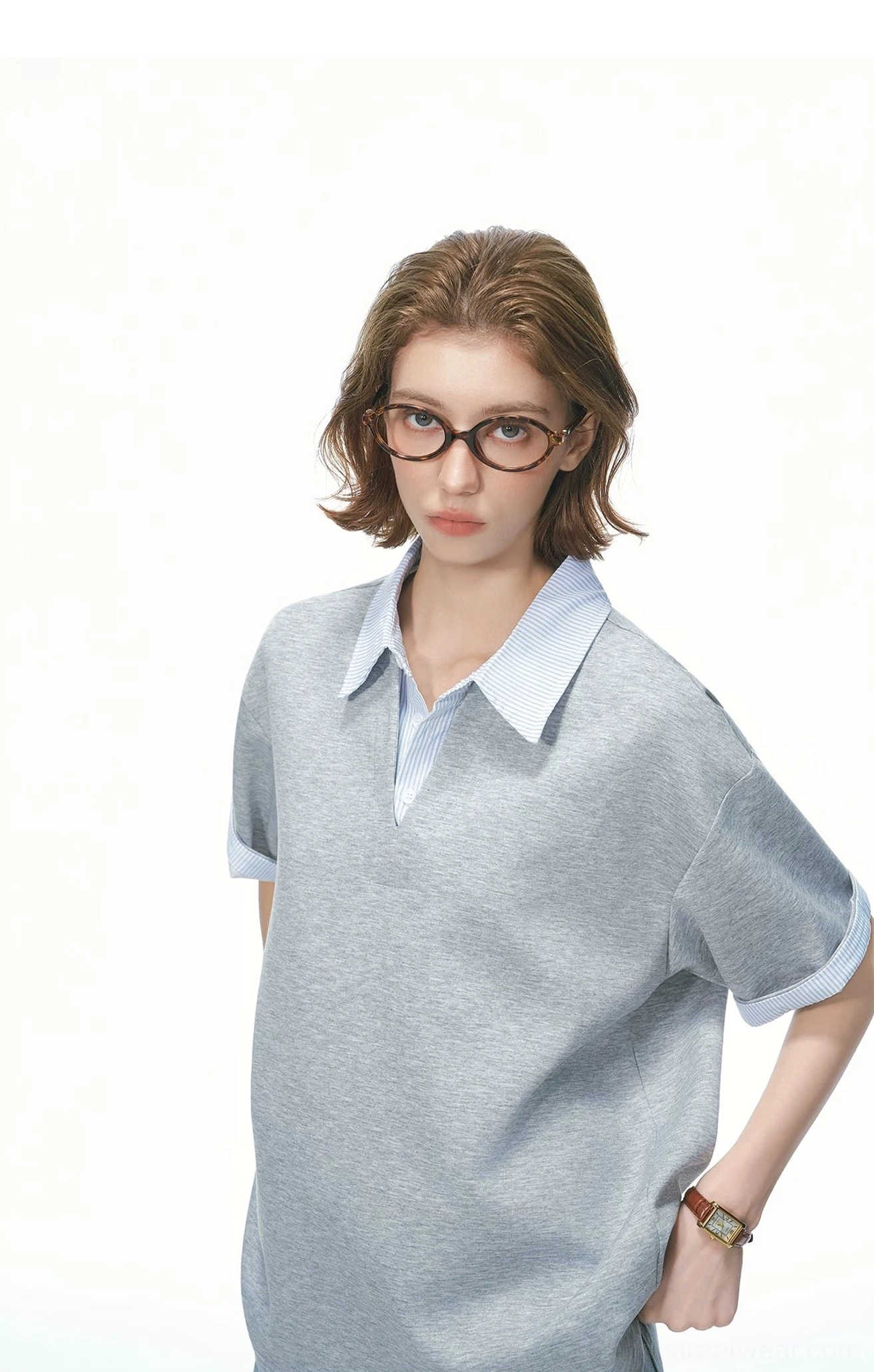 Close-up front view of heather grey oversized knit polo tee with light blue striped layered collar