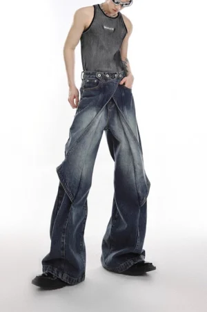 Indigo blue layered flared denim jeans with asymmetric crossover front panel in full front studio view