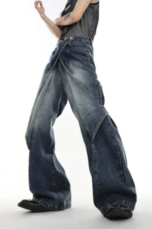 Vintage indigo layered cross-waist flared denim jeans shown in a low-angle front detail view