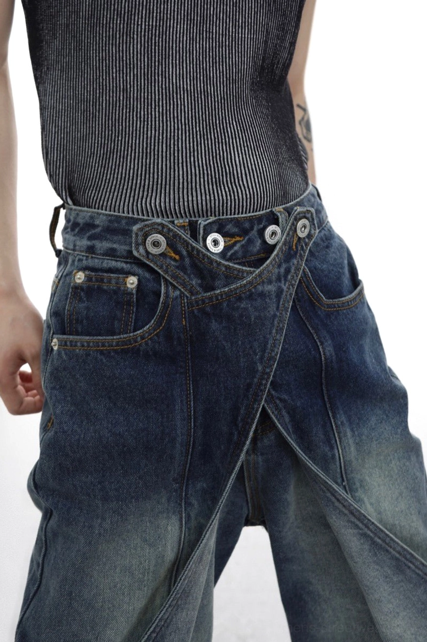 Close-up of multi-button adjustable crossover waistband on indigo layered flared denim jeans