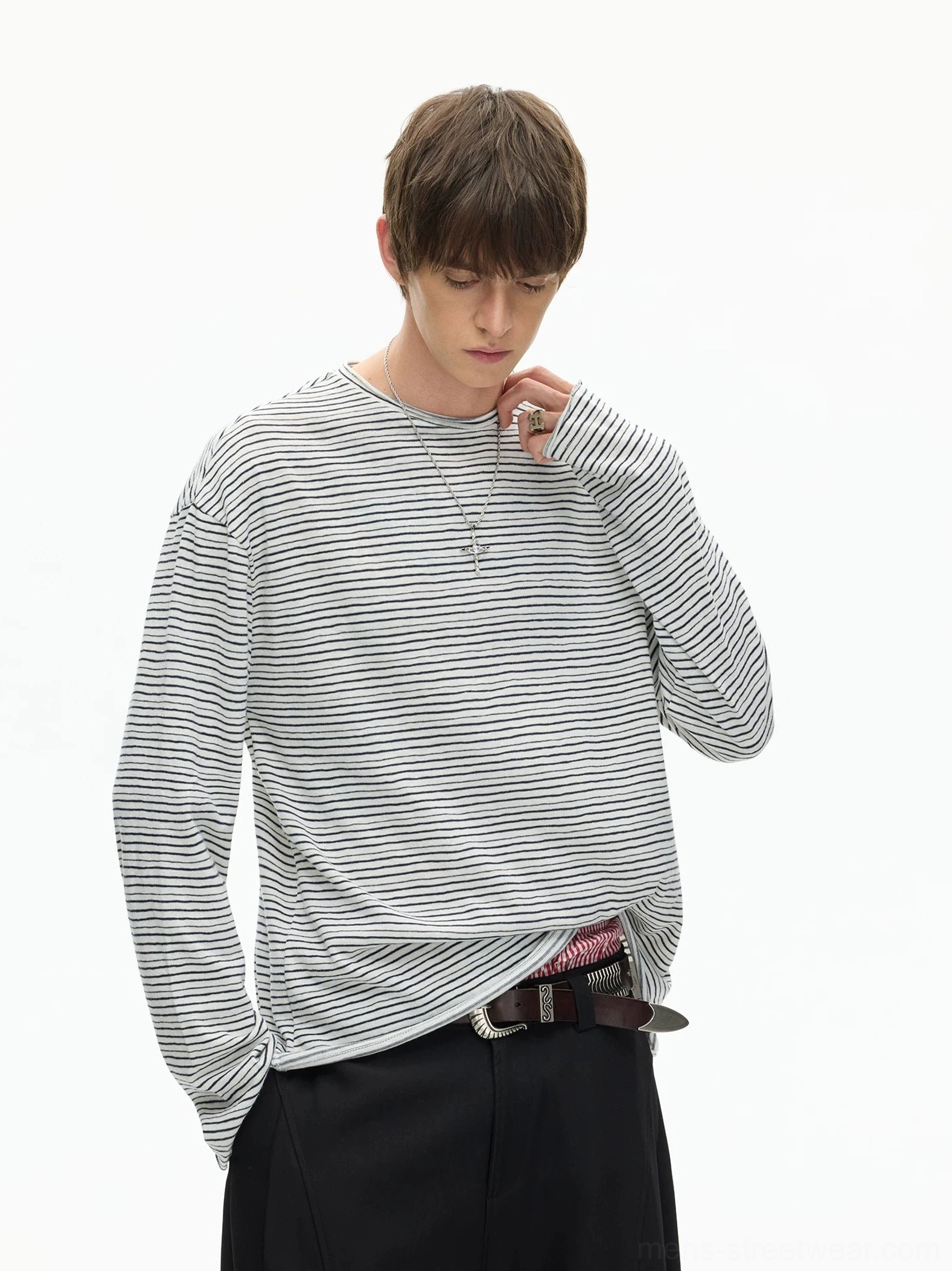 Light striped layered long sleeve T-shirt with exposed inner hem, drop shoulder silhouette, and black wide-leg pants in Seoul streetwear styling