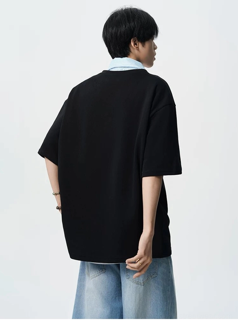 Back view of black oversized polo tee for men with dropped short sleeves and clean minimalist back panel