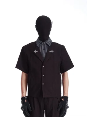 Black layered short-sleeve streetwear shirt with striped inner collar silver star details and textured vertical fabric front view