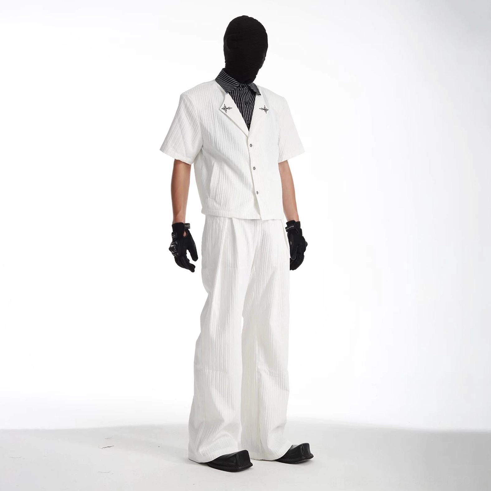 Layered striped short-sleeve streetwear shirt and wide-leg trouser set in a modern monochrome tailored silhouette