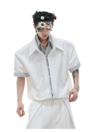 Front view of a layered white short sleeve button-up streetwear shirt with striped collar and cuff trims and oversized shoulders