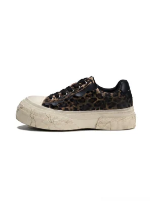 Side profile of leopard distressed platform canvas sneakers with thick weathered off-white platform sole black laces and black heel tab