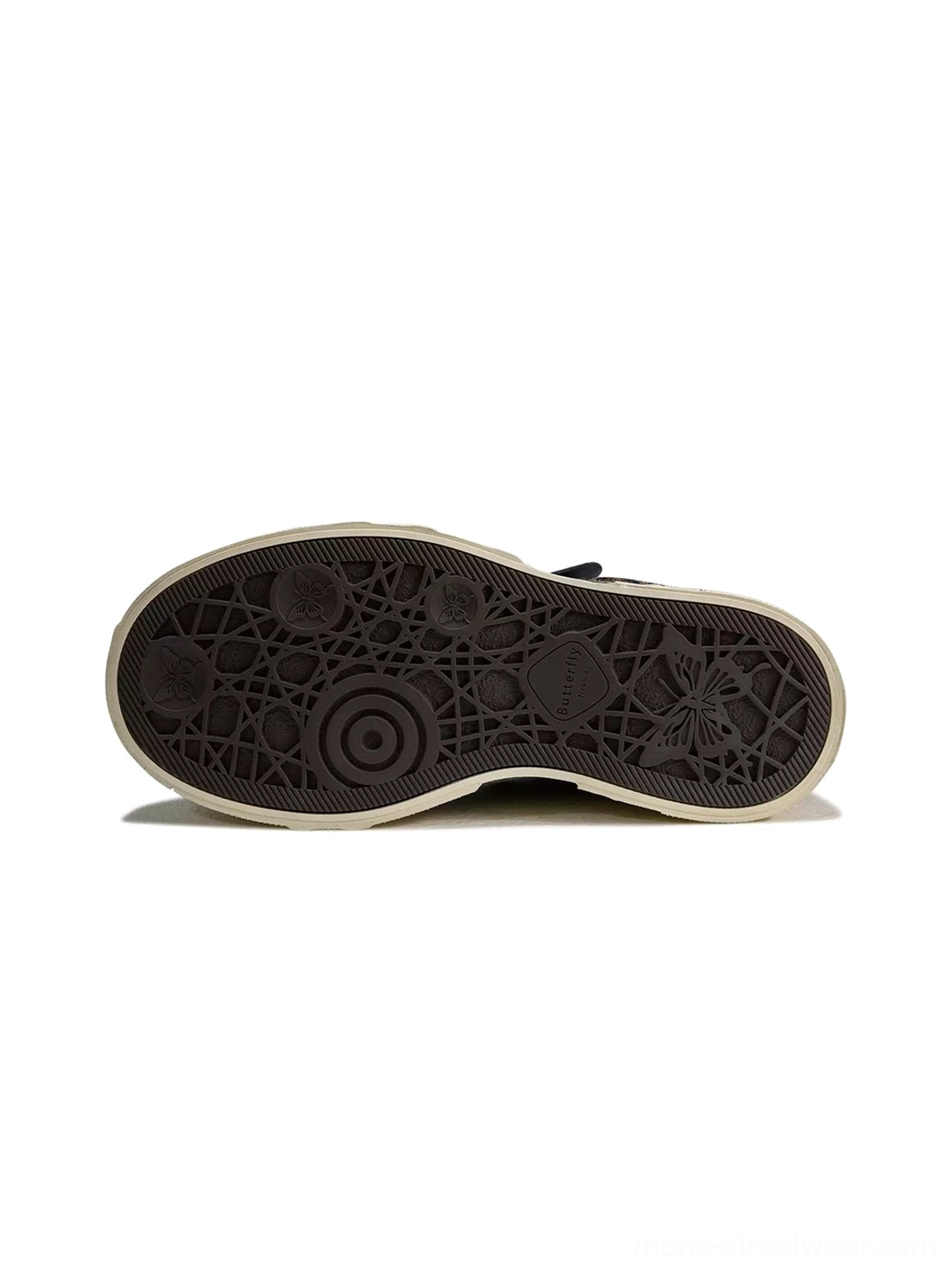 Bottom view of leopard platform sneakers showing carved black rubber outsole with circular and insect-inspired embossed patterns